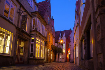 Fototapeta na wymiar Historic streets of illuminated Schnoor quarter at night