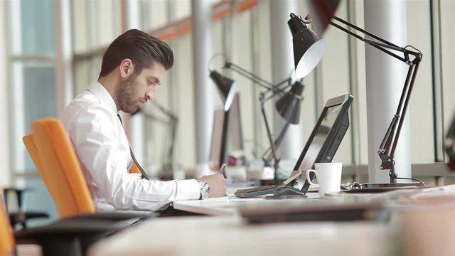 frustrated young business man working on laptop computer at office