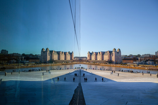 View on a side of the National Oslo Opera House with city reflected in glass