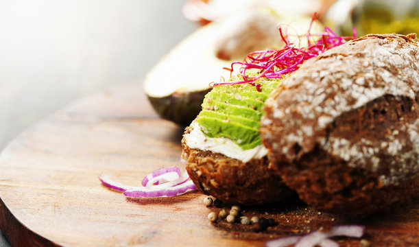 Avocado sandwich on dark rye bread made with fresh sliced avocad