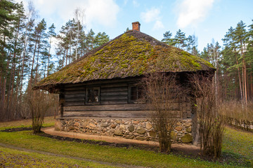 Obraz premium View of the rustic farm dwelling - stoned and wooden. Wooden architecture of North and Baltics