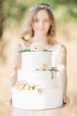 bride holding a wedding cake