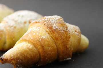Homemade fresh bagels on dark gray background.
