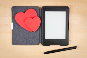 E-book reader with two red hearts and copy space