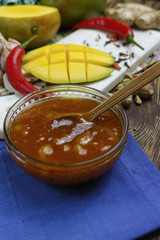 Bowl of homemade Mango Chutney on old wooden table