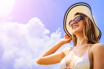 fashion and lifestyle concept - beautiful woman in hat enjoying summer outdoors