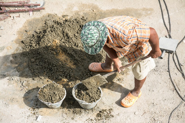 man mixing a cement in salver for applying construction