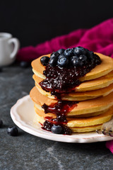 Homemade Pancake with blueberry jam on a black background