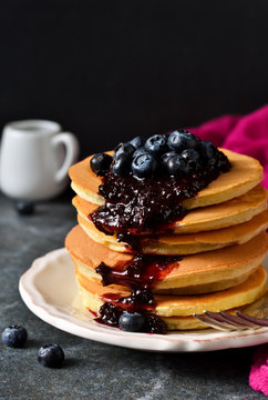 Homemade Pancake with blueberry jam on a black background
