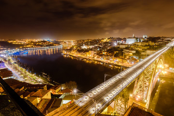 Dom Luis I bridge over Douro river illuminated at night, Porto, Portugal