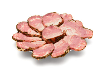 cut pieces of ham and bacon on a plate on a white background