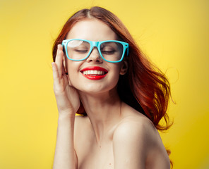 woman in glasses on a yellow background, a woman with glasses, woman