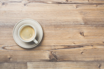 Cup of coffee on wooden vintage board background