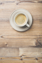 Cup of coffee on wooden vintage board background