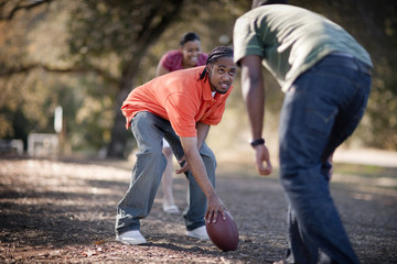 People playing American Football in park