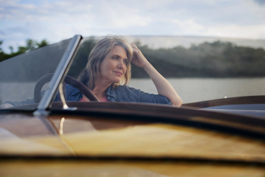 Mature woman sitting in boat.