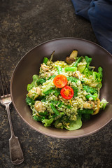 Pearl barley, green beans, tomato salad on ceramic plate
