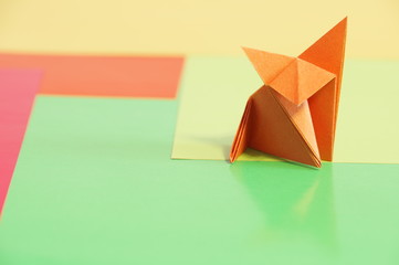 
Paper origami fox isolated on a colorful background