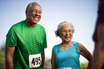 Smiling senior competitors at a sporting event.