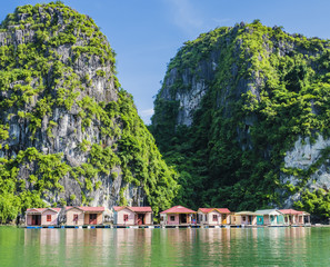 Fototapeta na wymiar Floating fishing village with rock island in background, Ha Long bay, Vietnam 