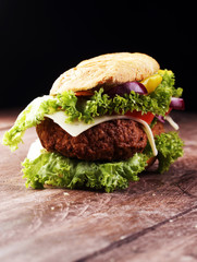 Tasty grilled prawn and beef burger with lettuce and tomato