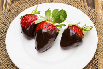 strawberry in chocolate over white background