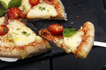 Hot true PEPPERONI ITALIAN PIZZA with salami and cheese. TOP VIEW Tasty traditional pepperoni pizza on board on wooden table with decoration