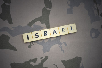 letters with text israel on the khaki background. military concept