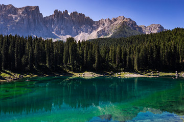 View of Karersee (Lago di Carezza), one of the most beautiful alpine lakes in the Italian Dolomites.