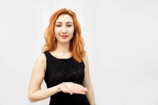 Beautiful young smiling girl with long hair holding a female swab isolated on white background. In his hand of menstrual tampon . Menstruation time. Hygiene