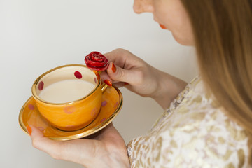 Woman drinking from a beautiful handmade orange cup