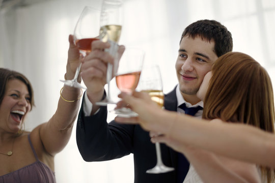 Newlywed couple toasting at their wedding reception