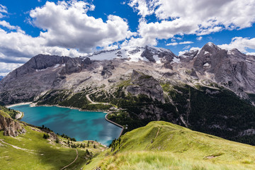 View of the Marmolada, also known as the Queen of the Dolomites and the Fedaia Lake. Marmolada is the highest mountain of the Dolomites, situated in northeast of Italy. - 134386256