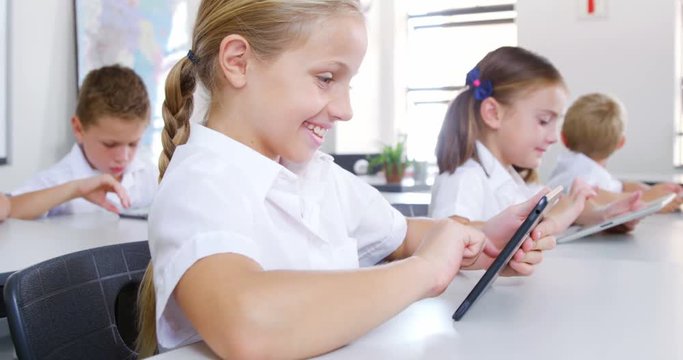 School kids using digital tablet in classroom at school 4k