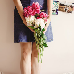 woman hipster holding peony bouquet close-up in the morning, swe