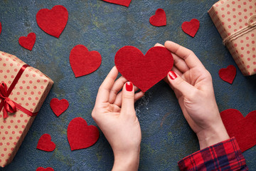 Heart in female hands. As a symbol of love. Background for Valentine's Day or romantic date. The concept of declarations of love. Flat lay. View from above.