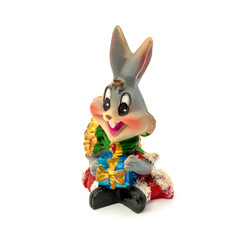 Statuette of grey rabbit with gift isolated on a white background