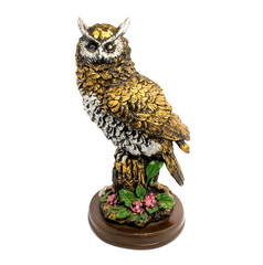 Statuette of gold owl with flowers isolated on a white background