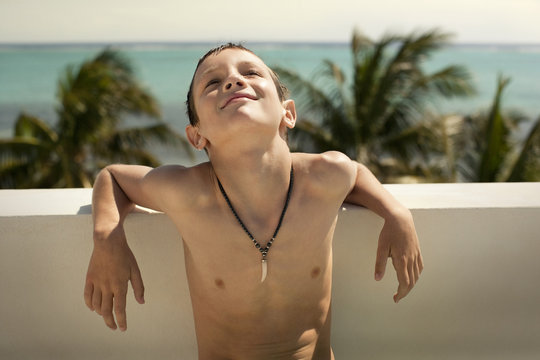 Young boy relaxing in the summer sun.