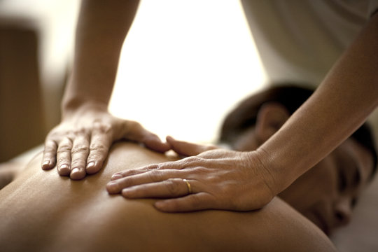 Woman receiving a back massage at spa