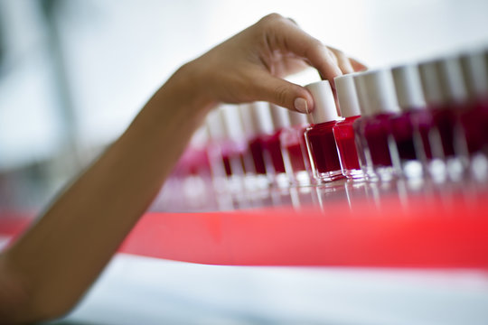 Woman choosing a nail polish color at a beauty salon