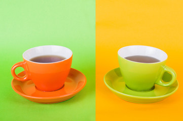 Two cups of coffee on a colored background