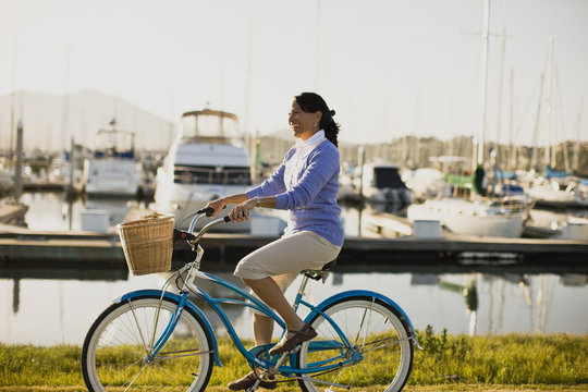 Mature woman riding her bike at the waterfront