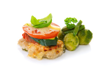 Fried mincemeat baked chops with vegetables and cheese.