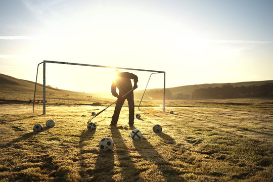 Groundskeeper raking a soccer field