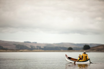 Man canoeing with his preschool age son.