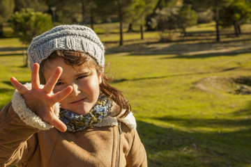 Close up baby girl with give me five expression