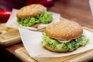 yummy burger. serving cheeseburger or hamburger with salad tomat