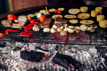 juicy vegetables and meat grilling. beef steak mushrooms corn pe