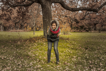 Full shot portrait of beautiful woman in autumn background